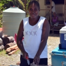 Lady of Kia Village preparing fish.