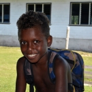 A young boy in Bareho Village is excited to start school.
